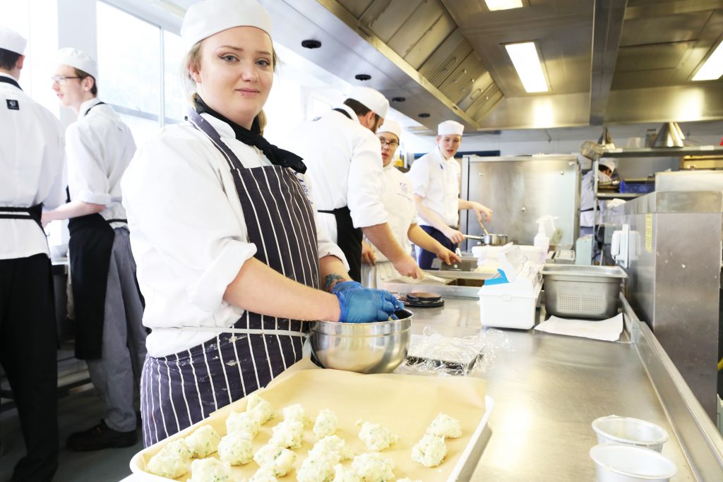 Catering student in kitchen