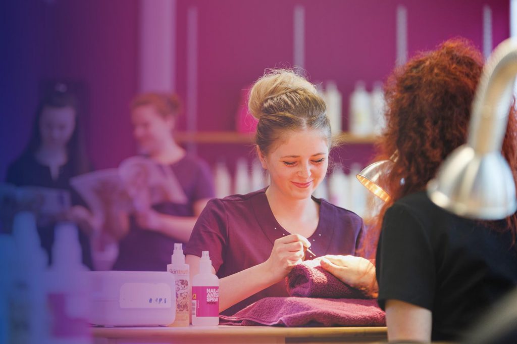 Manicurist doing a client's nails