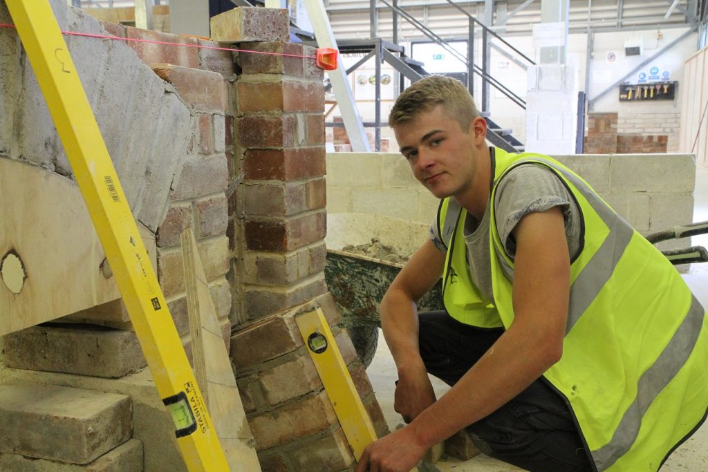 Bricklaying student building a wall in the workshop 