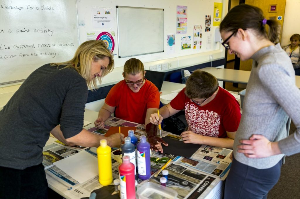 Foundation learning students during a painting activity in the classroom