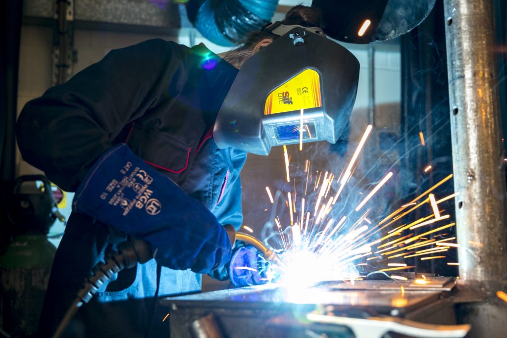 Person using an electric welding machine