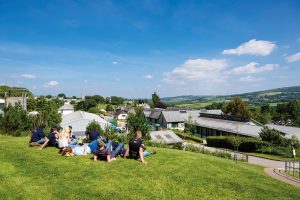 Students sitting on hillside at Duchy College Stoke Climsland